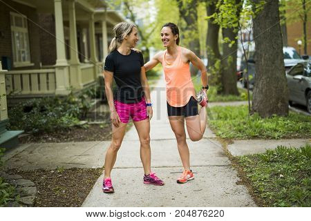 Two Beautiful Female runner outside having fun