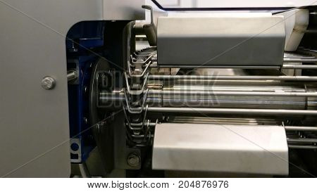 Food factory automated robotic machine. Conveyor product line for cooking and packing rations and food packs. Robotics and automatic lines used instead of human labor on factories and plants.