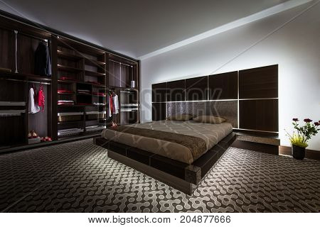 Dark toned interior of modern bedroom in apartment