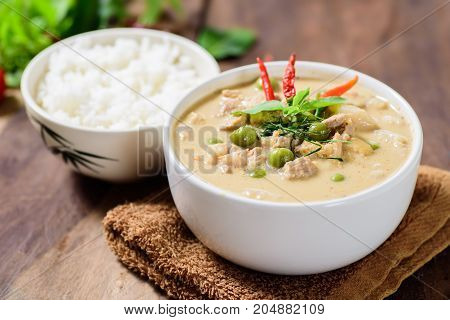 Thai food (Phanaeng curry),red curry with pork and cooked rice in a bowl on wooden background
