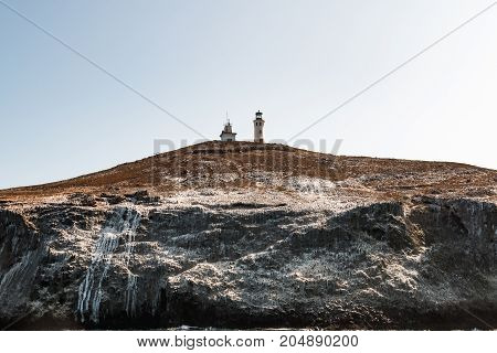 Anacapa lighthouse stands high atop the volcanic Anacapa Island in Southern California, part of the Channel Islands National Park.