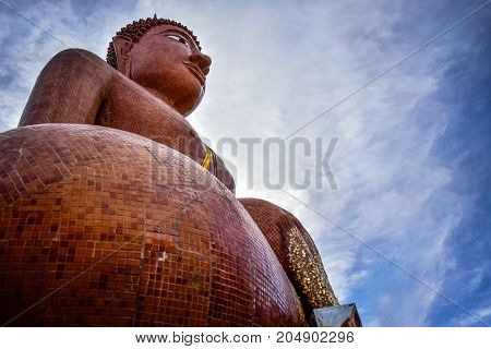 The big Buddha image in Thai temple at Nakhon prathom. See the blue sky and clouds are on background looking so beautiful.