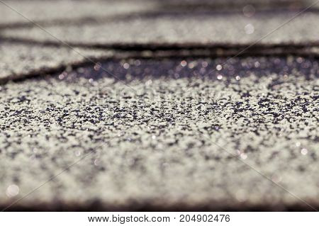 Old Flexible Tile Roof Of The House. Small Depth Of Field. The Surface Of The Tile Has An Inhomogene