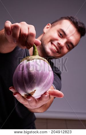 The concept of agriculture. Eggplant in male hands. Healthy Eating.