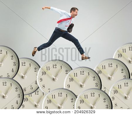 Businessman running over alarm clock. Collage about tardiness and lack of time. concept of business acceleration