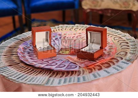 Wedding ring and bride's price or dowry in Thai wedding ceremony. Selective focus and shallow depth of field.