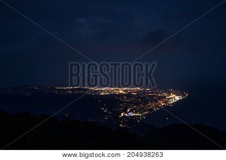 Beautiful view of the city at night from a great height from the mountains