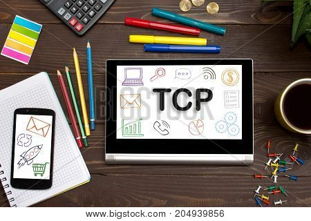 TCP Transmission Control Protocol the inscription on the touch-screen tablet on the table of a businessman