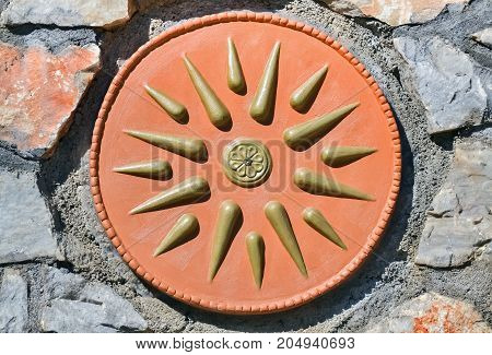 Closeup of a historical emblem named Vergina Sun or Macedonian Star