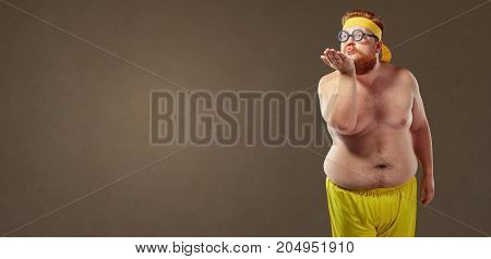 Funny fat man in glasses sends an air kiss.