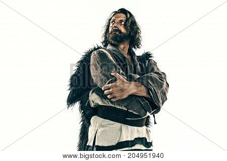 Portrait of a brutal bald-headed viking in a battle isolated against a white background. Early medieval period. Actor in makeup. concept of vagrancy and survival
