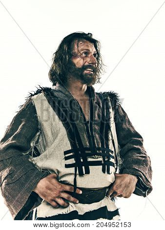 Actor in makeup, a poor man isolated on white studio background. The bum in canvas rags. concept of vagrancy and survival
