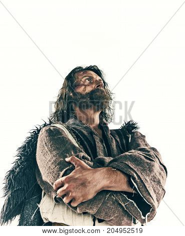 Portrait of a brutal bald-headed viking in a battle isolated against a white background. Early medieval period. Actor in makeup. concept of vagrancy and survival