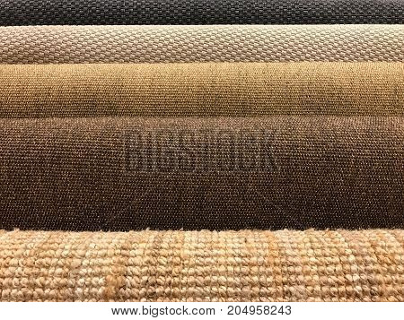 Samples of brown woven sisal and natural fiber carpet roll for texture and background