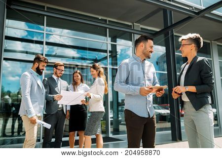 Young attractive designers talking on break about business plans