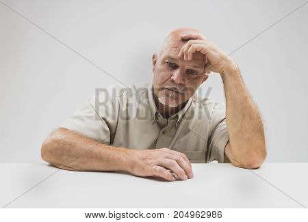 Despondent Senior Man Sitting Thinking