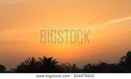 The rising sun painted the sky with orange hue on cloud