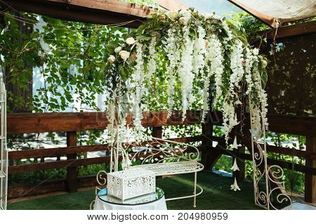 Wedding arch decorated with white hanging flowers