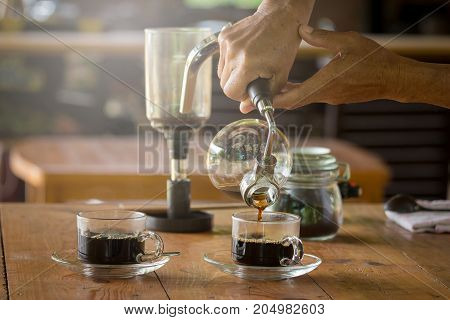 Close Up Of Siphon Vacuum, Coffee Cup And Siphon Vacuum Coffee Maker At Shop