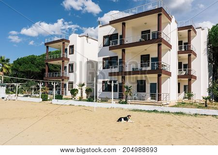 ALBANIA GOLEM- September 21 2015: Guest three-storey houses with balconies on the coastal line of the Adriatic Sea sandy beach with a volleyball court