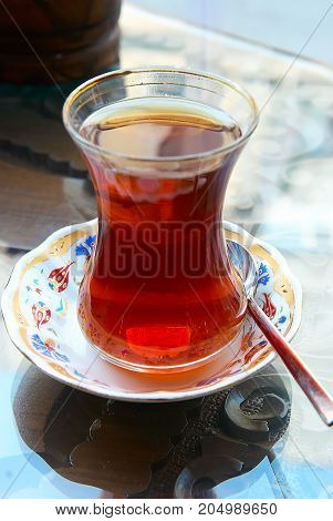 Turkish tea on a plate with spoon