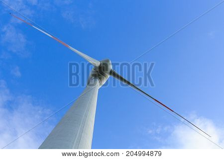 View of wind turbine producing alternative energy