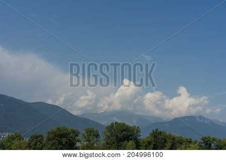 lago maggiore lake scenery with mountain water and cloudy sky in summer from boat