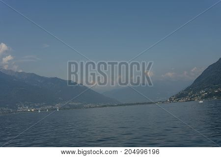 lago maggiore lake scenery with mountain water and cloudy sky in summer from boat