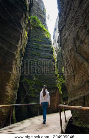 Woman in Unique rocks mountain Adrspasske skaly in national park Adrspach in Czech republic