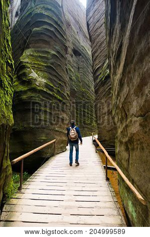 Man in Unique rocks mountain Adrspasske skaly in national park Adrspach in Czech republic