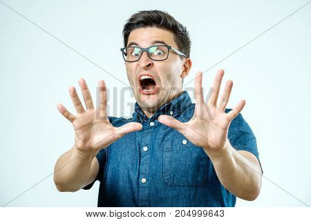 Man With Scared Expression On His Face Making Frightened Gesture With His Palms