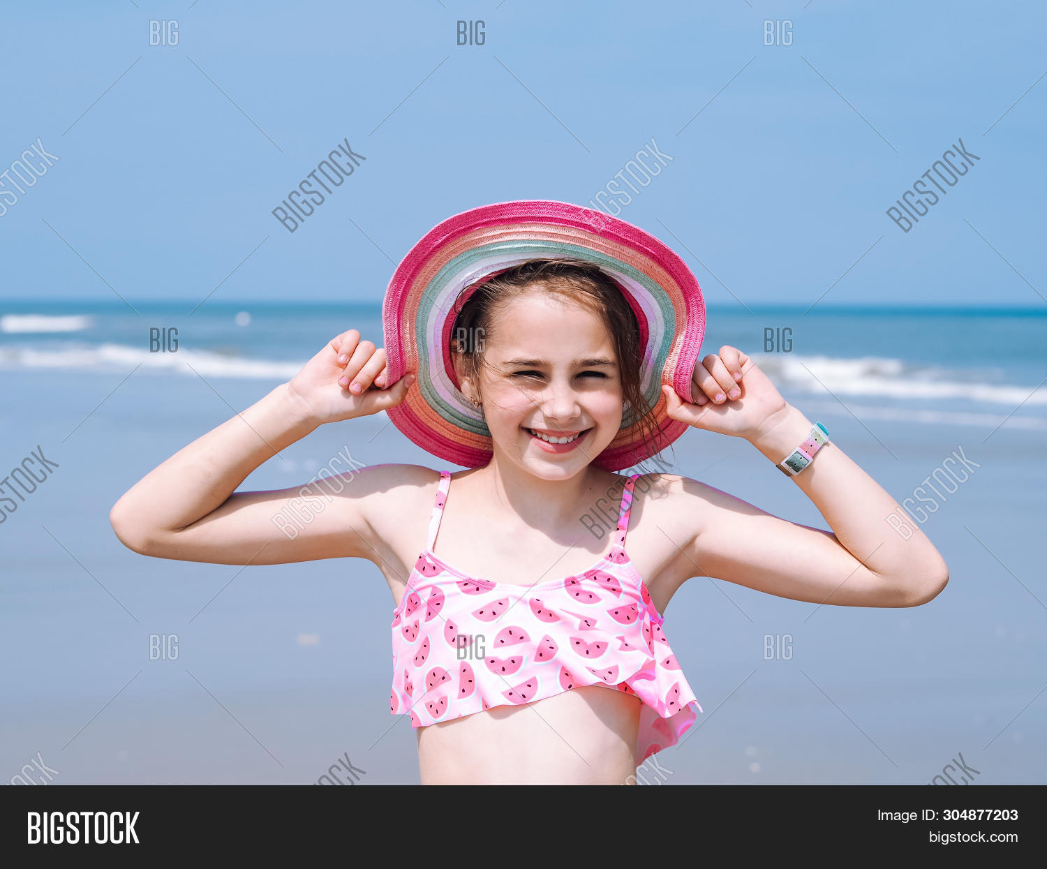 Vew Of A Beautiful Teen Girl Wearing In Colorful Hat And Swimsuit Enjoying