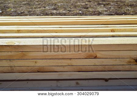Stacked Lumber. Folded Wood.closeup Wooden Boards.the Surface Of The End Of The Board.lots Of Planks