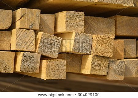 Stacked Lumber. Folded Wood.closeup Wooden Boards.the Surface Of The End Of The Board.lots Of Planks