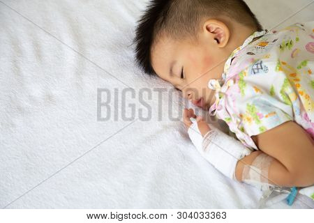 Asian Baby Boy Sleeping On Bed With Infusion Set At Child Department In The Hospital. Children With 