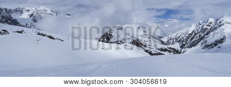 Panoramic View On Winter Mountain Landscape At Stubai Gletscher Ski Area With Snow Covered Peaks At 