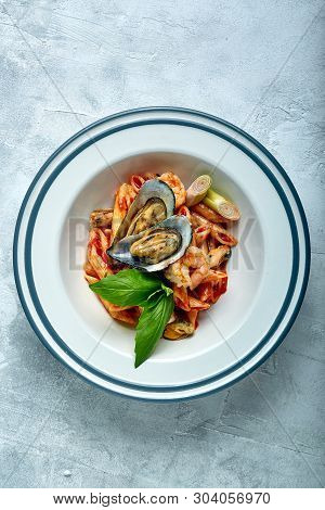Pasta With Seafood And Tomato Sauce. Penne With Shrimp, Octopus, Mussels, Vongli In Tomato Sauce Wit