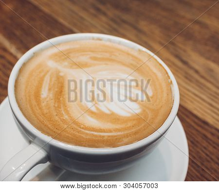 Coffee Latte Or Cappuccino In White Mug On Wooden Table, Dark Background.