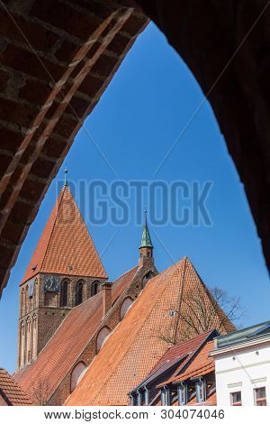 Maria Church Viewed From Under The Greifswalder Tor City Gate In Grimmen, Germany
