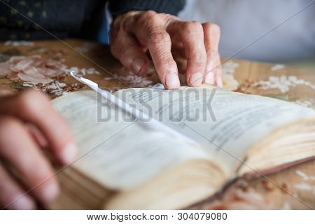 Old Woman Hands On The Open Prayer Book (christian Prayer Book In Ukrainian). Reading The Book. Pray
