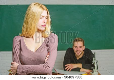 Taking An Exam. Female Student With Schoolmaster At Examination. Pretty Woman Standing Hands Crossed