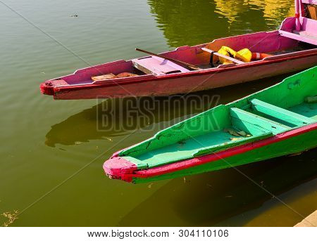 Wooden Boats Waiting For Tourists On Gadsisar Lake At Sunny Day In Jaisalmer, India.