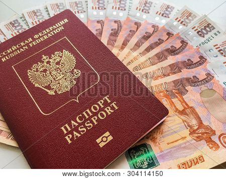 Russian Money And Passport On A Gray Background, Close-up