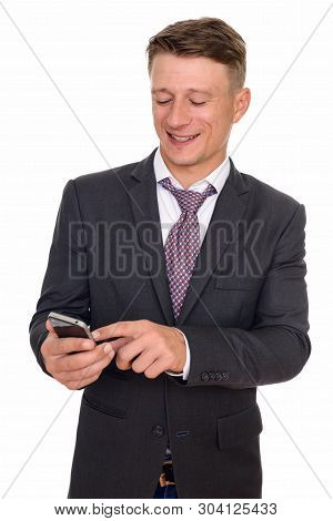 Studio Shot Of Young Happy Caucasian Businessman Using Mobile Ph