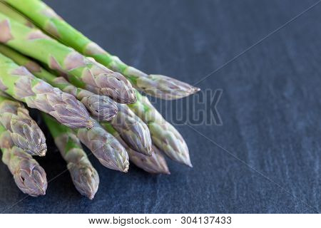 Bunch Of Fresh Green Asparagus On A Dark Slate Background, Horizontal, Copy Space