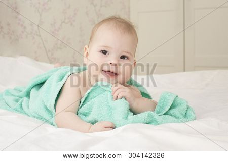 Beautiful Baby Girl 6 Months Playing With A Towel After Bathing. Laughing Happy Child Portrait, Good