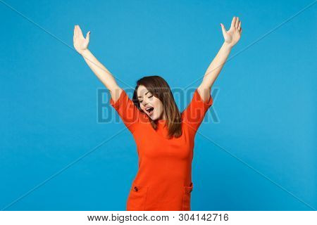 Beautiful Excited Brunette Young Woman Wearing Red Orange Dress Raised Hands Up, Winner Say Yes Isol