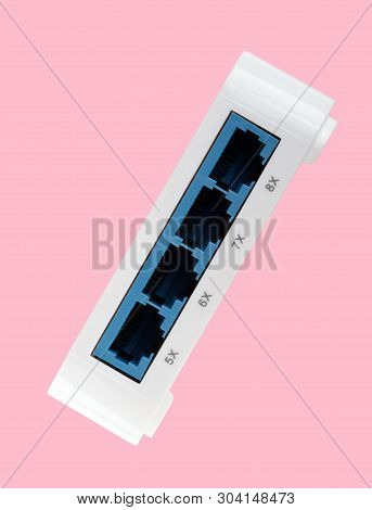 White 8 Port Plastic Ethernet Switch Isolated On Pink Background At Dry Day