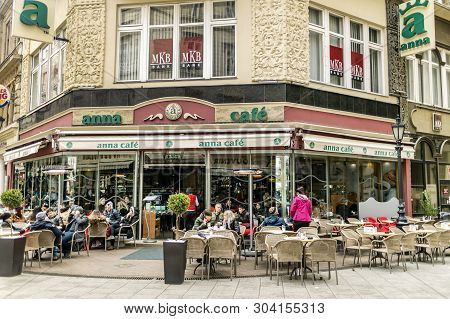 Budapest, Hungary - 24 August, 2018: People Sit At Anna Cafe By Famous Tourists Vaci Street In Budap