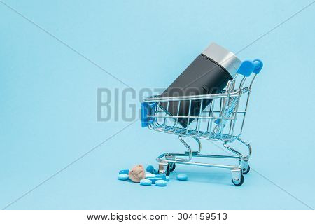 Hearing Aid And Blue Pills On Blue Background. Medical, Pharmacy And Healthcare Concept. Copy Space.